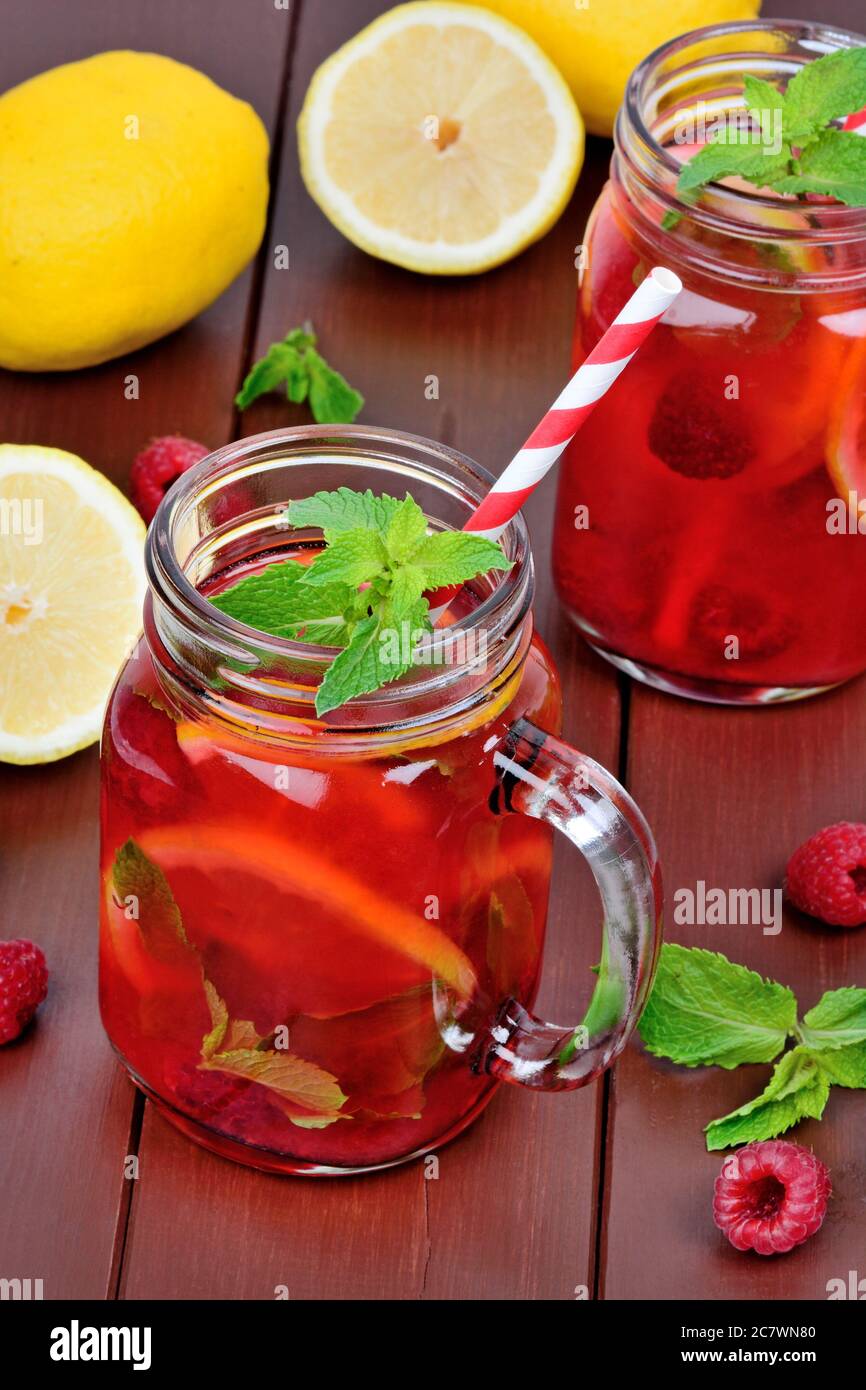 Raspberry lemonade in a jars on a wood table Stock Photo