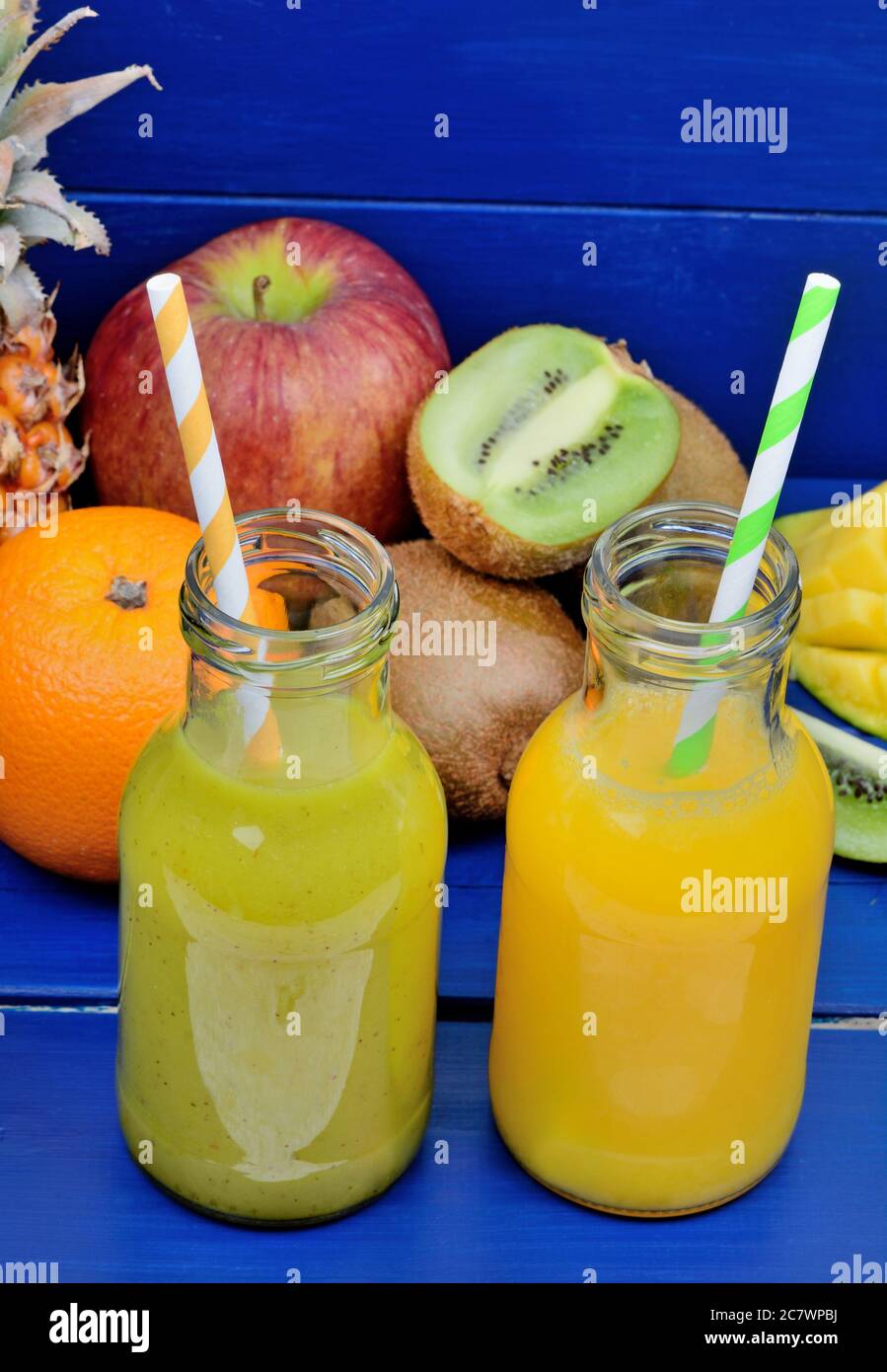 Fresh glasses of juice with fruit mix placed on wooden table. Detox or diet concept Stock Photo