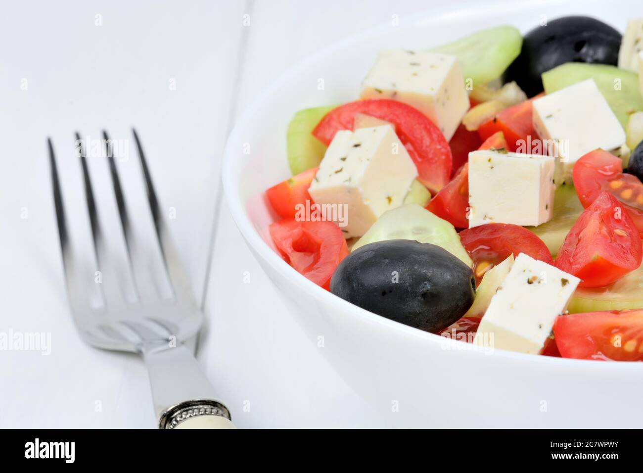Fresh of vegetables salad with cheese in a bowl on a wood table Stock Photo