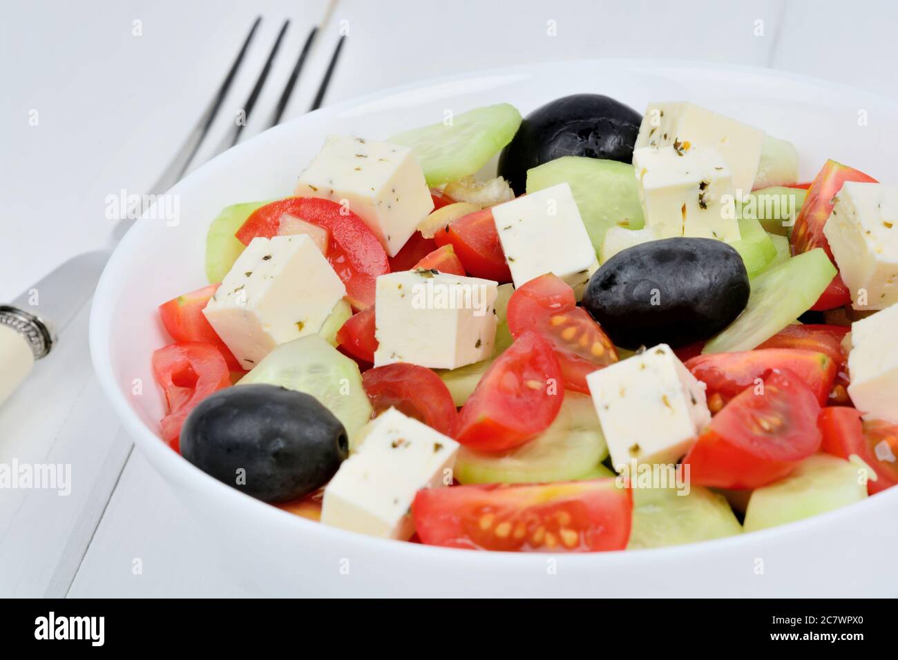 Close up of vegetables salad with cheese in a bowl on table Stock Photo