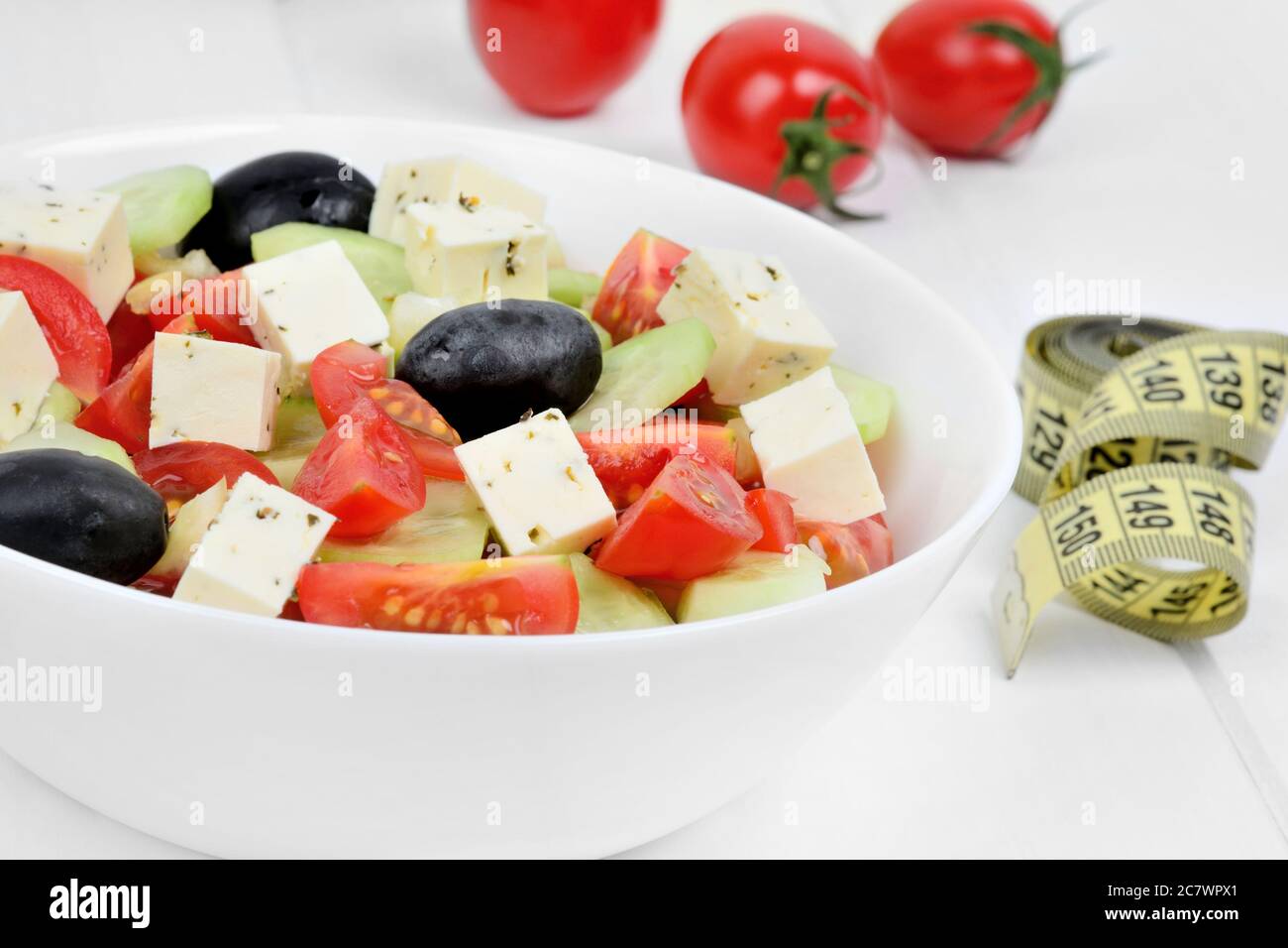 Vegetables salad in a bowl with centimeter on wooden table Stock Photo