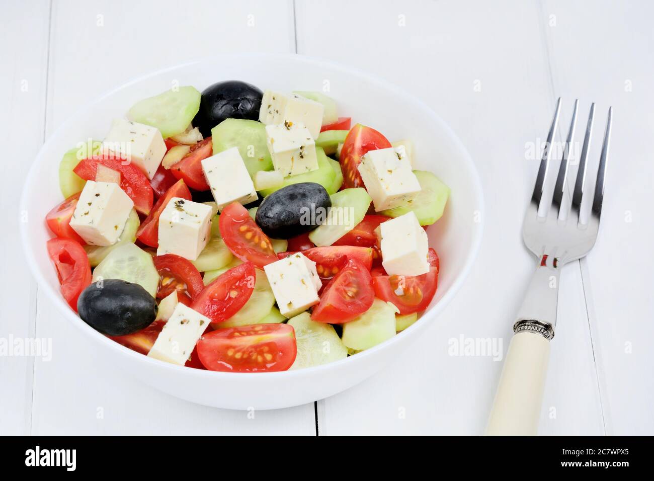 Vegetables salad with cheese on white wood table Stock Photo