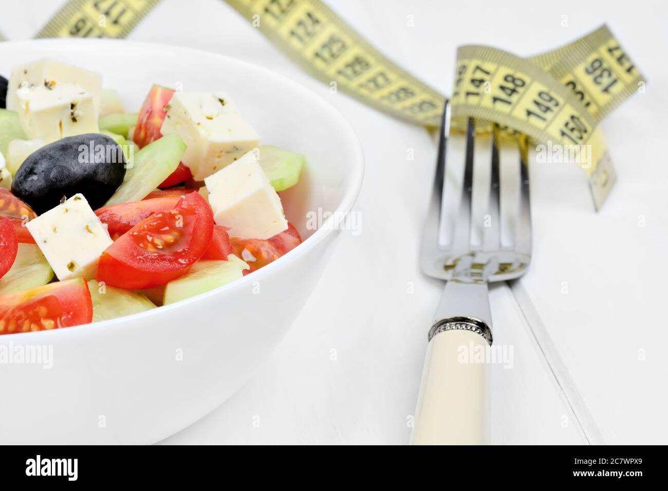 Vegetables salad in a bowl with centimeter on a wood table Stock Photo