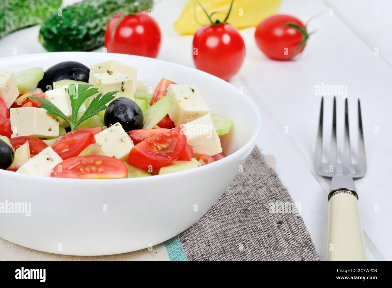 Vegetables salad with cheese in a bowl on table Stock Photo