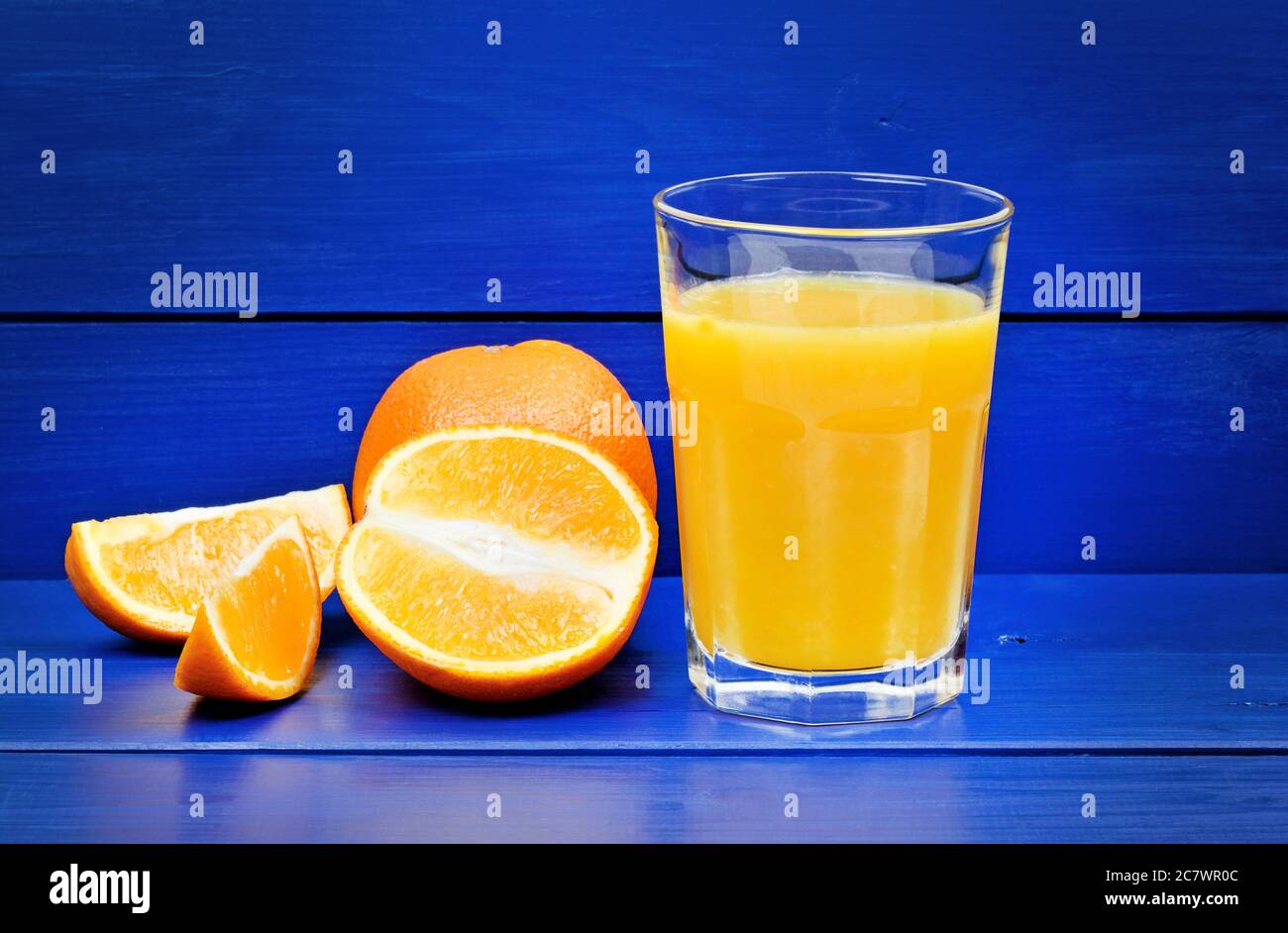 Orange juice in a glass on a blue  wooden table Stock Photo