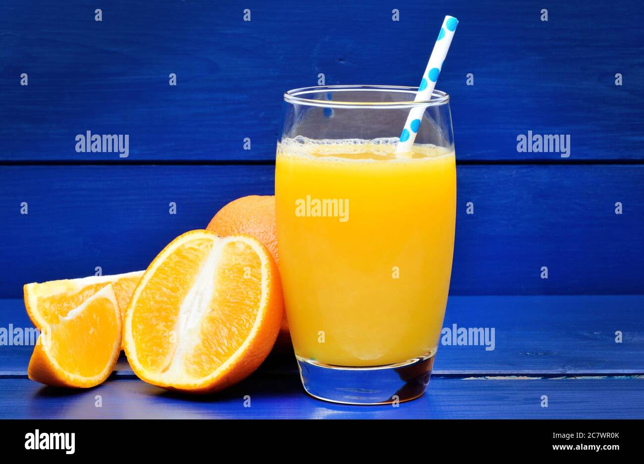 Orange juice in a glass on blue wooden background Stock Photo