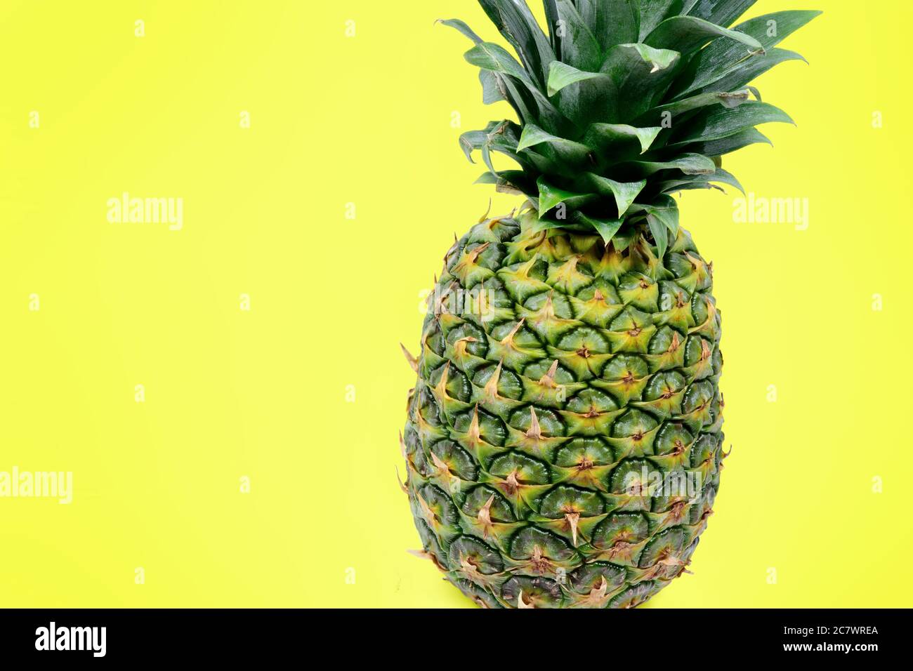 Close up of pineapple on yellow background Stock Photo