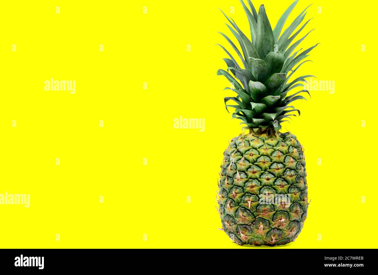 Close up of delicious pineapple on yellow background Stock Photo