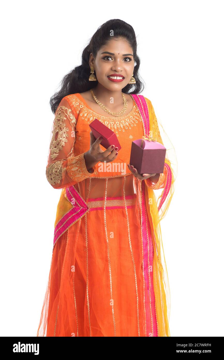 Portrait of young happy smiling Indian Girl holding gift boxes on a ...