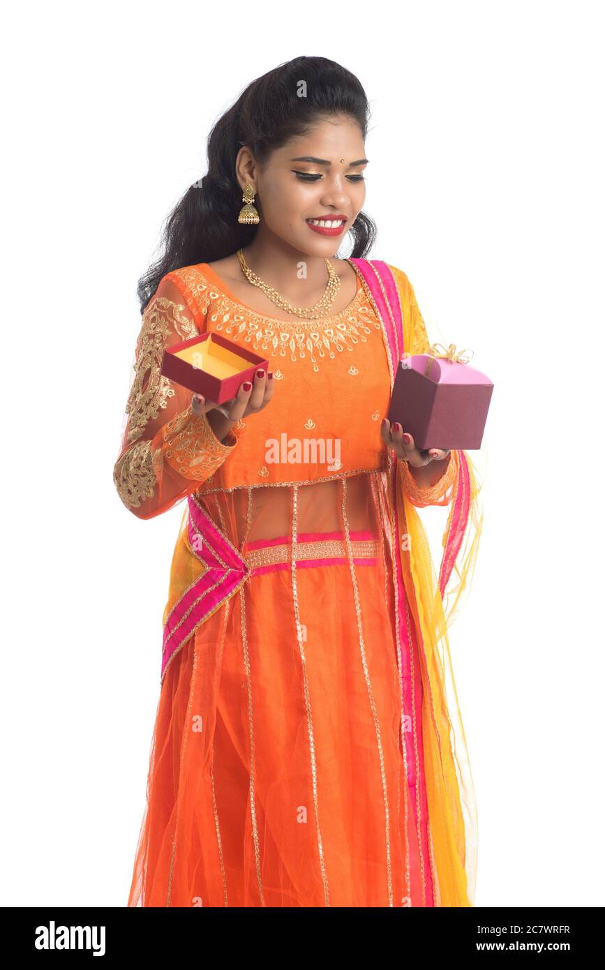 Portrait of young happy smiling Indian Girl holding gift boxes on a ...