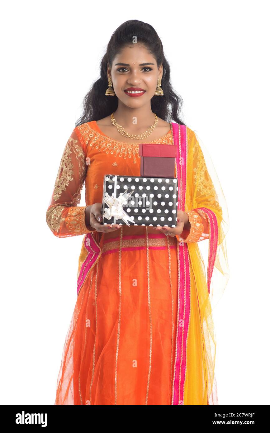 Portrait of young happy smiling Indian Girl holding gift boxes on a ...