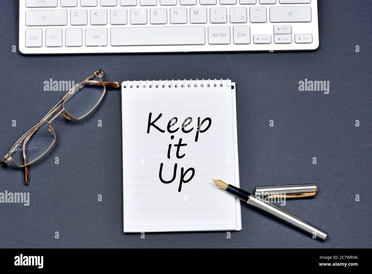 Keep it up text on notebook on a black background Stock Photo