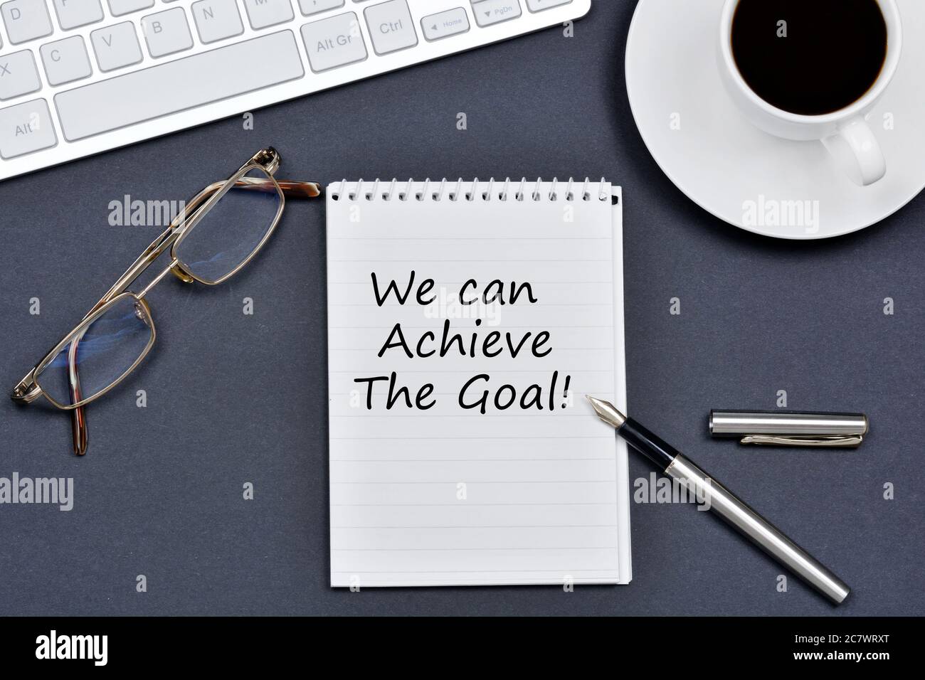 We can achieve the goal. Text on notebook on a black background Stock Photo