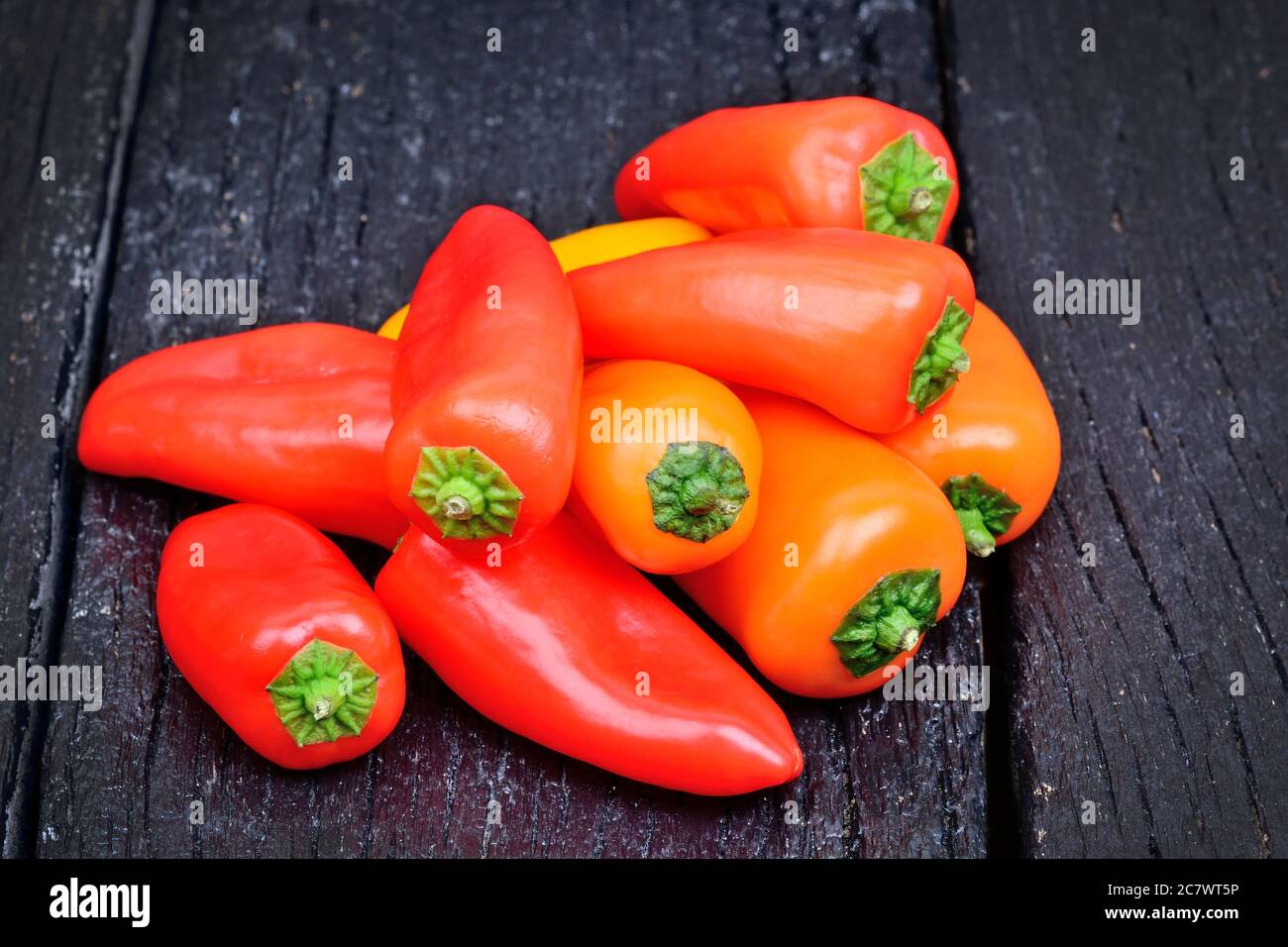 Group of colorful pepper on a wood table Stock Photo - Alamy