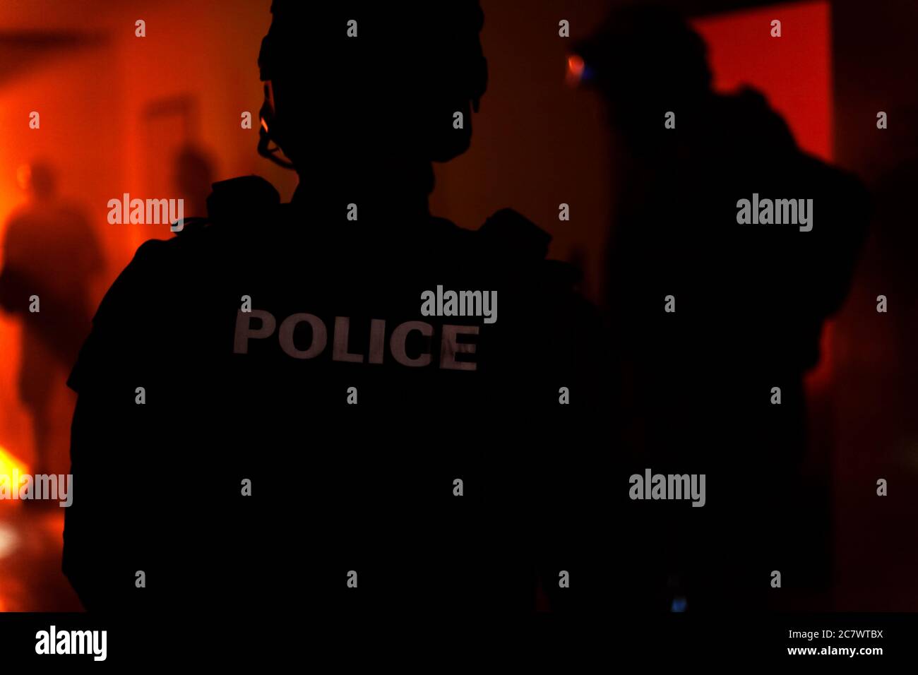 Silhouette of a police officer. Police commando in action, arresting the perpetrator in the building Stock Photo