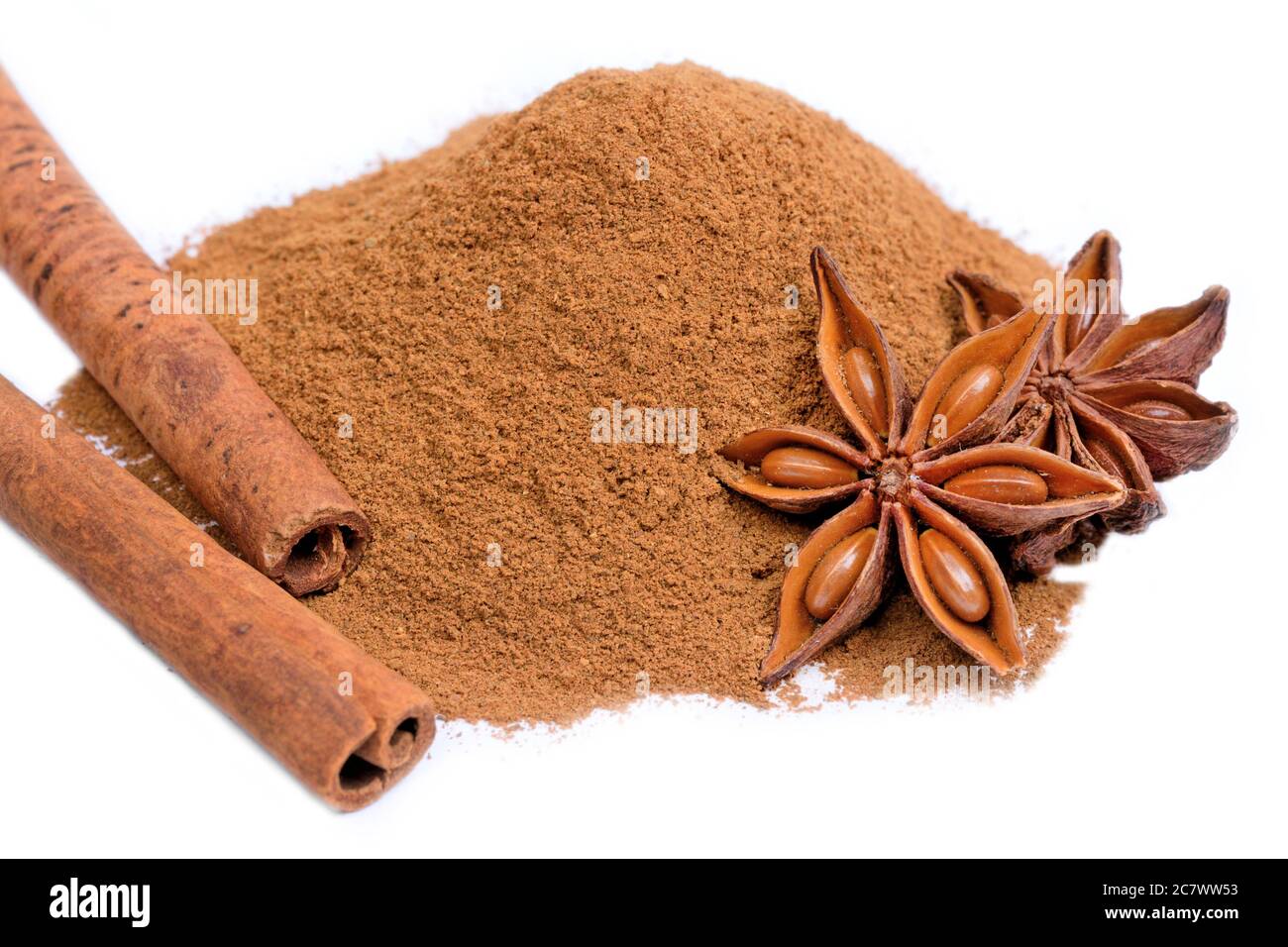 Close up of cinnamon powder and sticks with star anise on white background Stock Photo