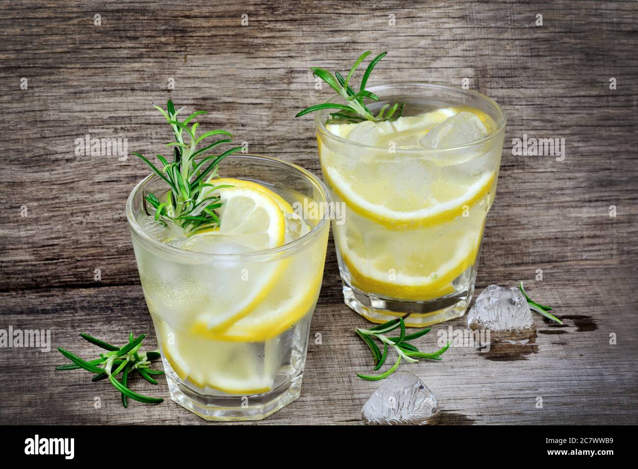 Fresh lemon with water in a glasses on old wood table Stock Photo