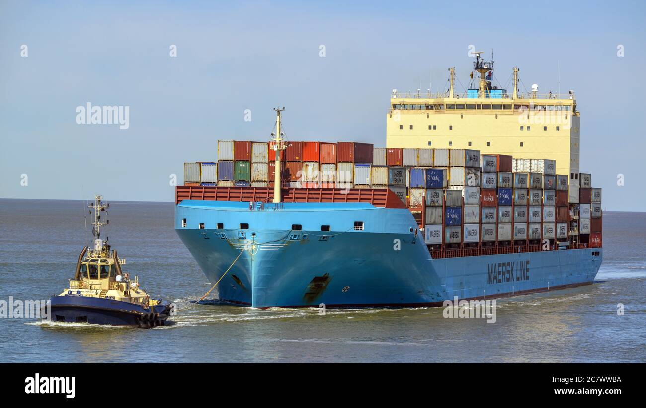 The container ship arrives at the Cape Town cargo port. He is guided