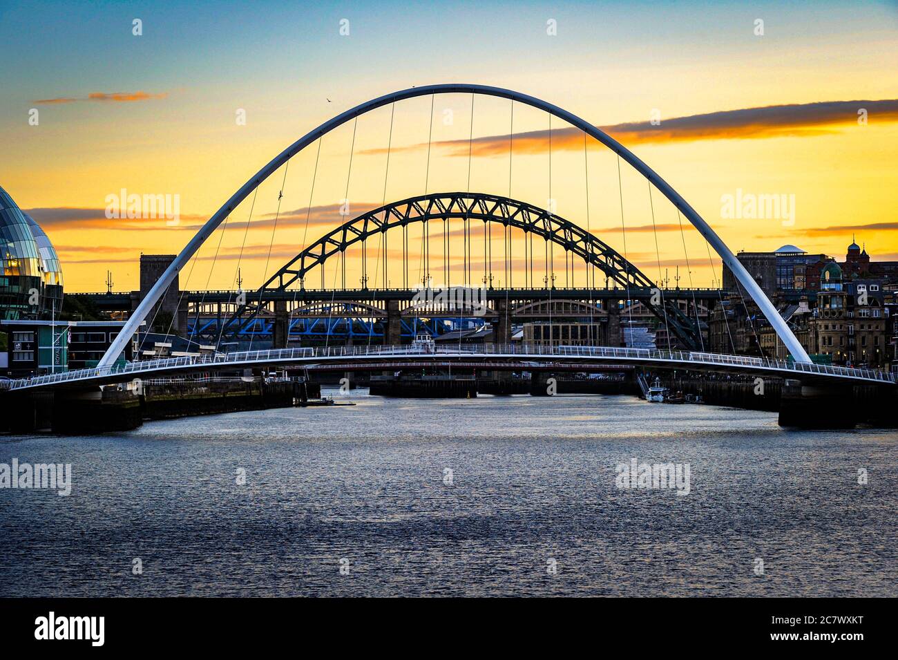 NEWCASTLE, UK. 19 July 2020. The sky turning from blue to yellow over the bridges in Newcastle, Tyne and Wear, England. Photo © Matthew Lofthouse Stock Photo