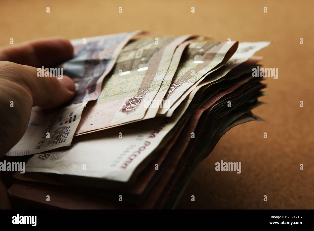 Closeup shot of a male hand holding a pack of Russian Ruble banknotes Stock Photo