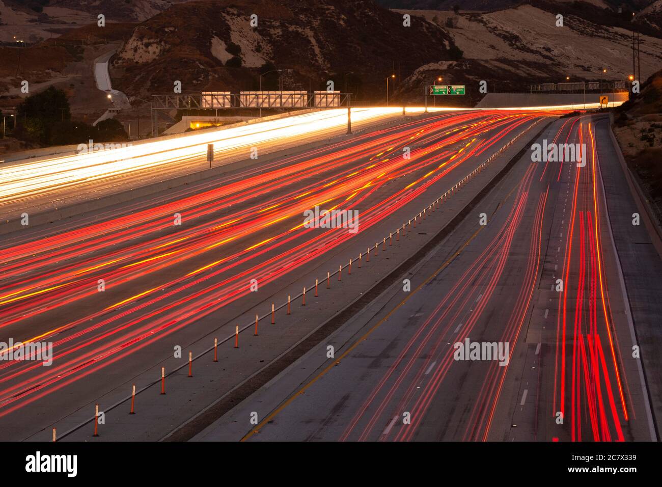 Streaks of tail lights of passing cars on a Los Angeles freeway at dusk Stock Photo