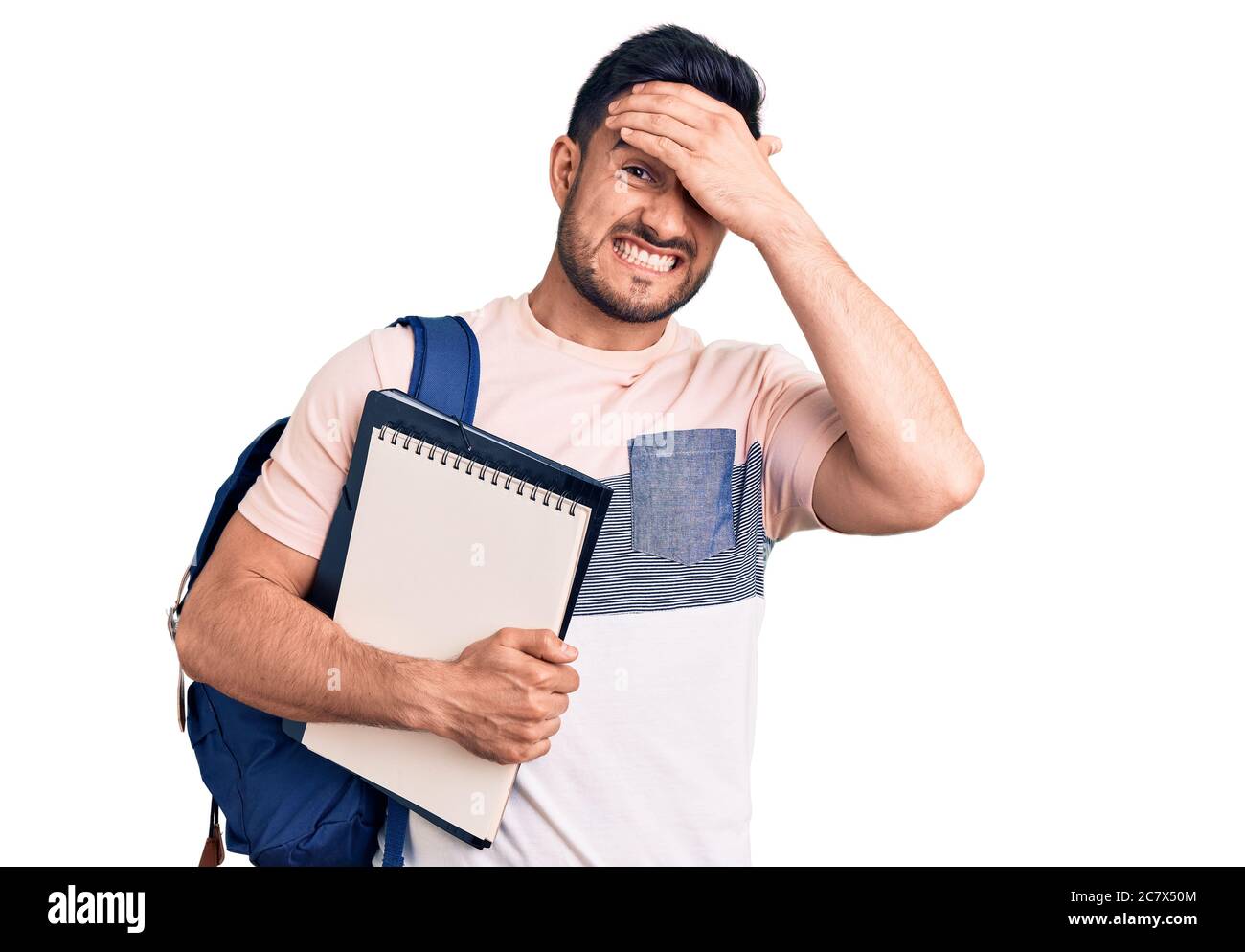 Young handsome man wearing student backpack and notebook stressed and ...