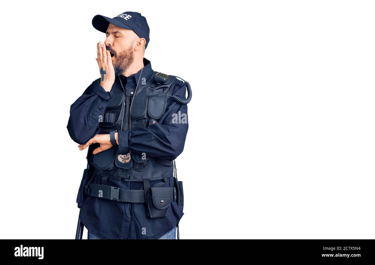 Young handsome man wearing police uniform bored yawning tired covering mouth with hand. restless and sleepiness. Stock Photo