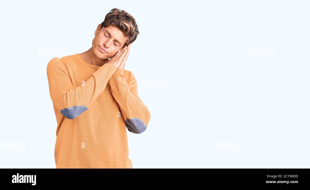 Young handsome man wearing casual clothes sleeping tired dreaming and ...