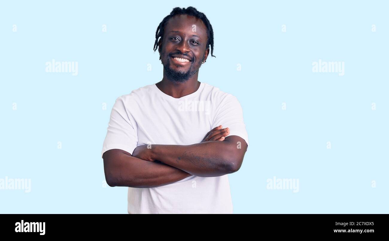 Young african american man with braids wearing casual white tshirt ...