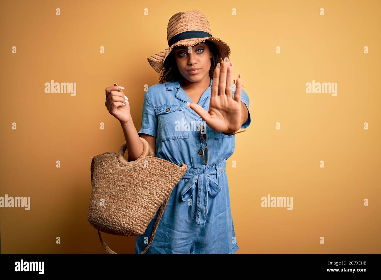 Young african american tourist girl on vacation wearing summer hat and ...