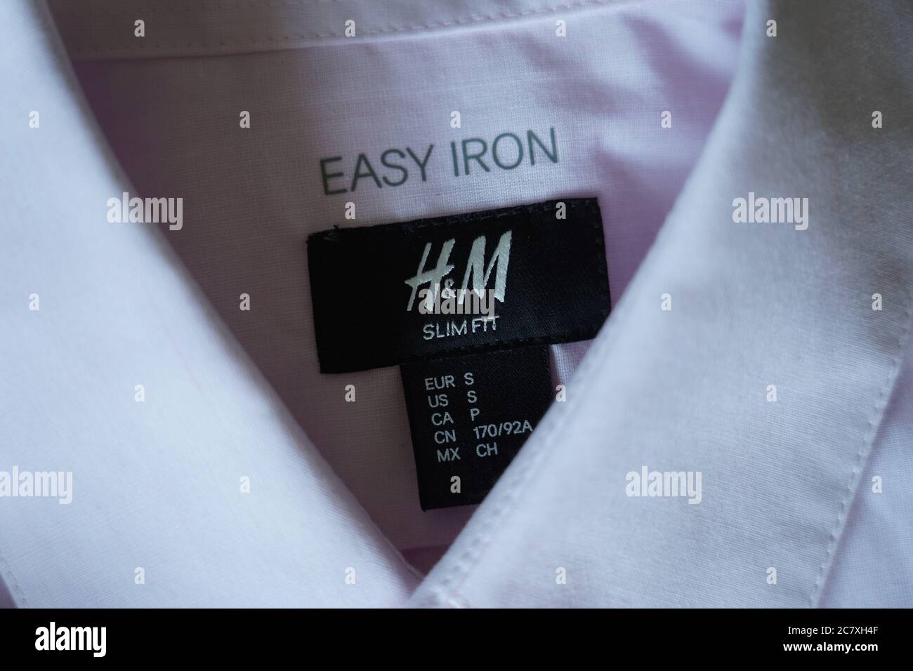 h&m slim fit easy iron size small dress shirt close up label Stock Photo