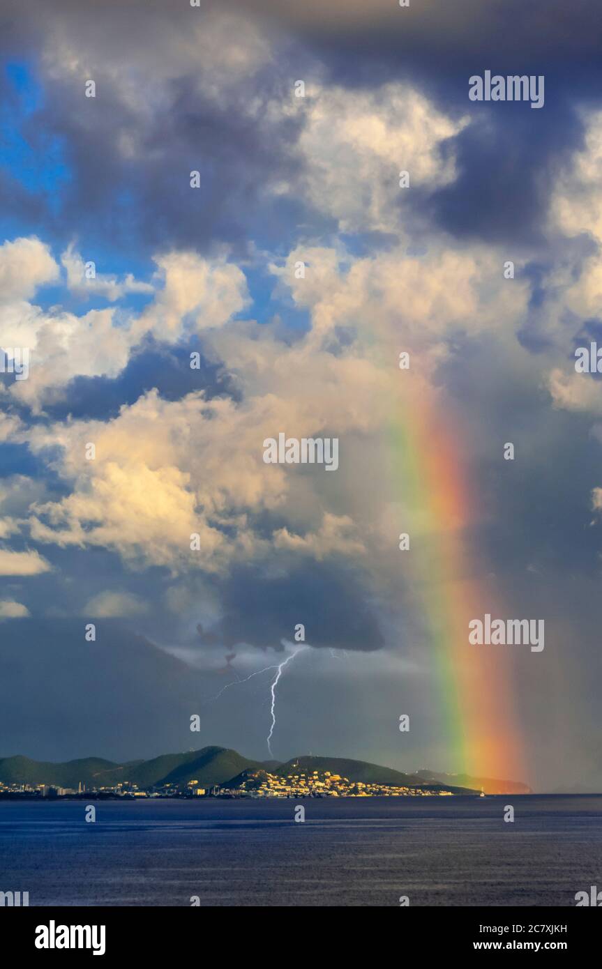 Storm clouds and rainbow near St. Maarten, Caribbean Islands. Stock Photo