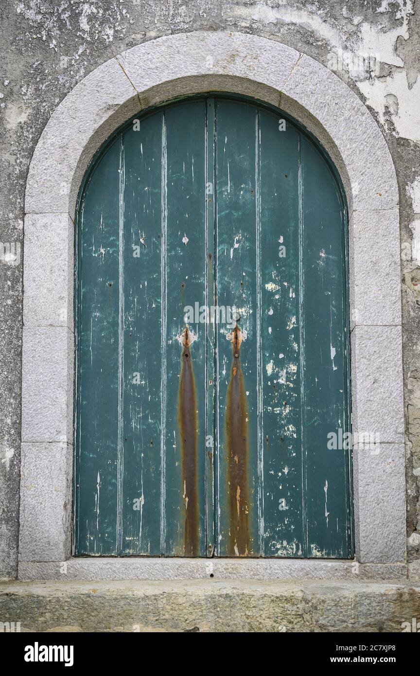 Vertical shot of an old blue wooden window of an aged building Stock ...