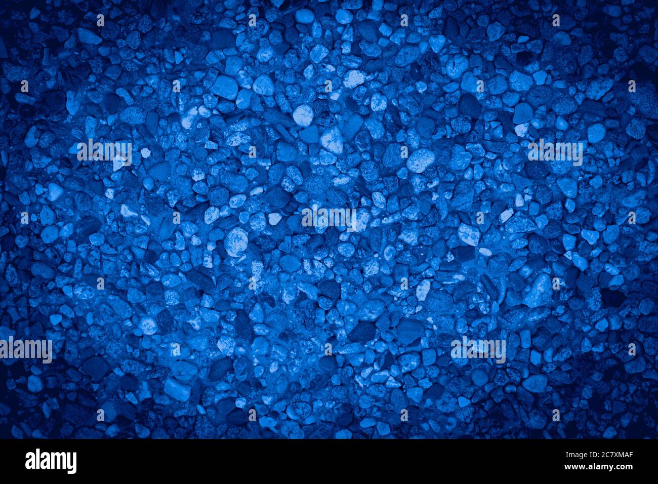 Pile of small stones background texture with colorful blue overlay