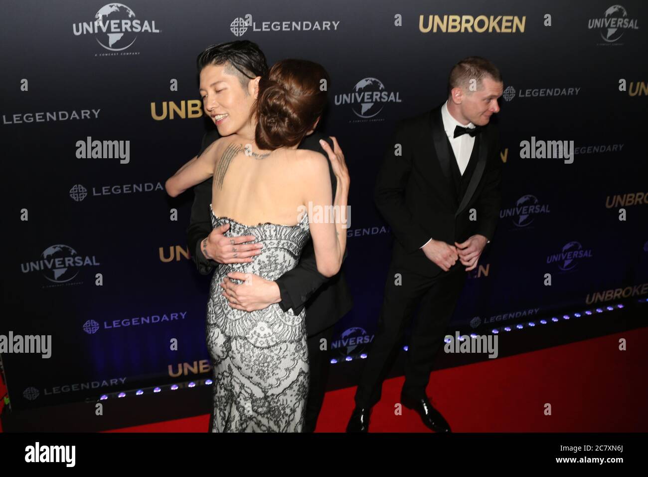 Unbroken producer and director Angelina Jolie with actors Miyavi and Jack O’Connell on the red carpet for the world premiere of ‘Unbroken’ at the Stat Stock Photo