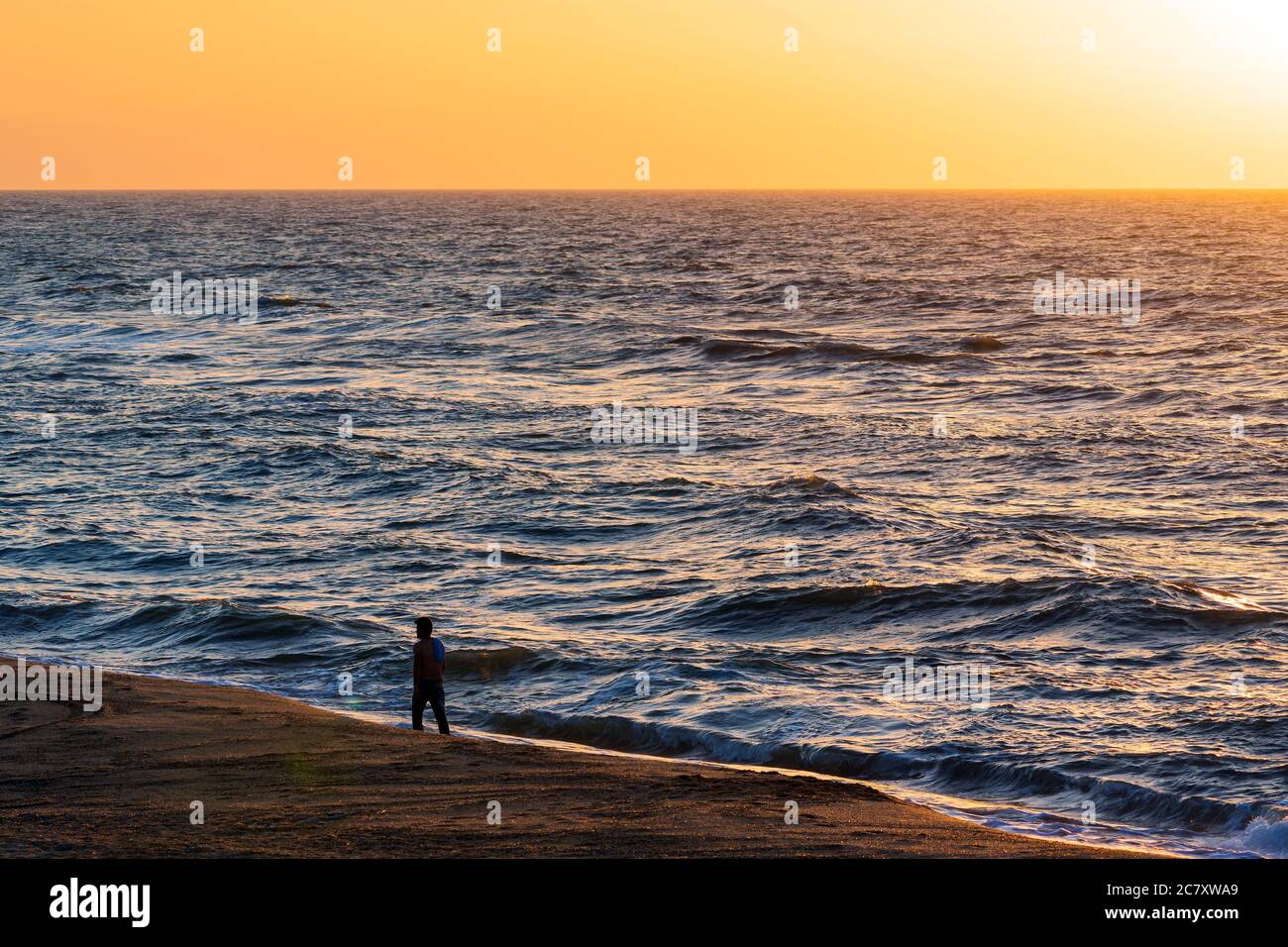 Empty sandy beach man walking hi-res stock photography and images - Alamy
