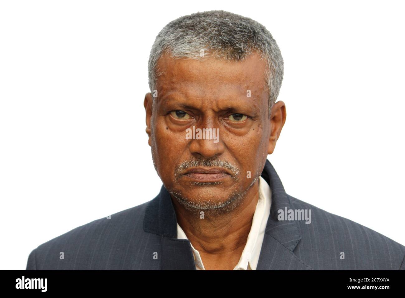 Angry, sad or worried looking senior Indian man face portrait on white background. Stock Photo