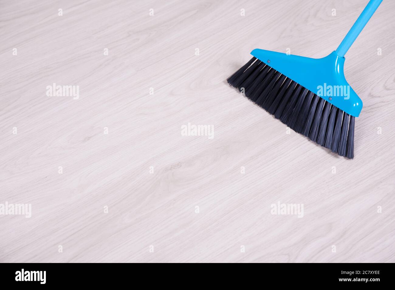 cleaning concept blue broom sweeping laminated floor Stock Photo Alamy