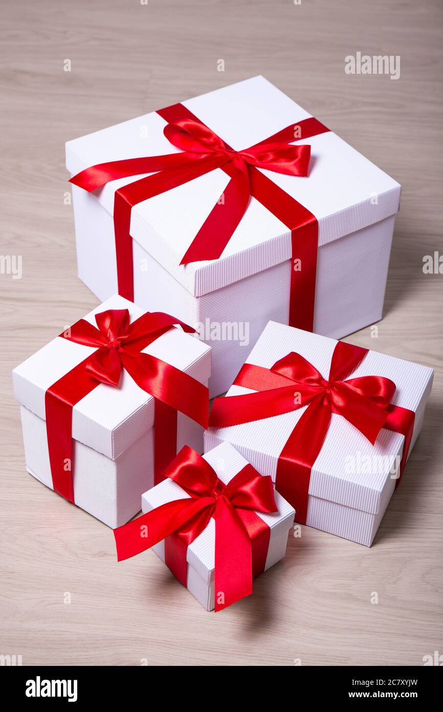 Christmas concept -present boxes with red ribbon on wooden background ...