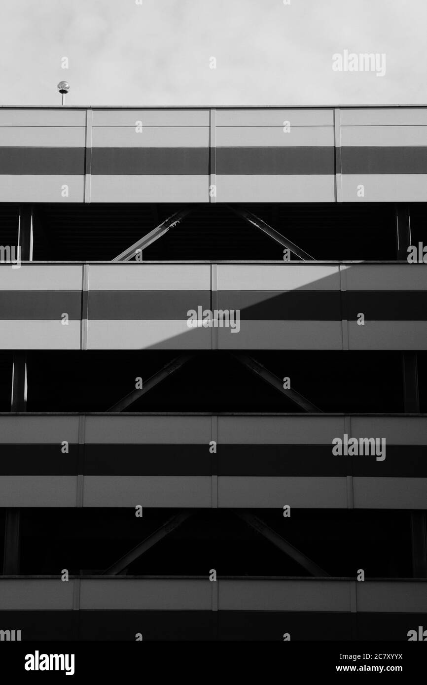 Vertical grayscale shot of a modern building's exterior during daylight ...