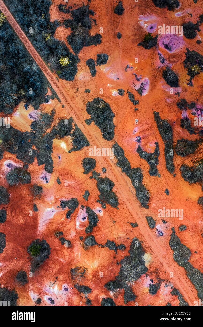 Gant, Hungary - Aerial horizontal drone view of abandoned bauxite mine with warm red and orange colors at sunset. Red bauxite texture Stock Photo