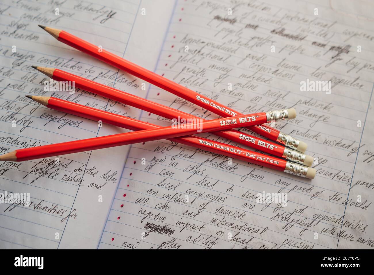 IELTS red pencils and essay notebook for the English exam Stock Photo -  Alamy