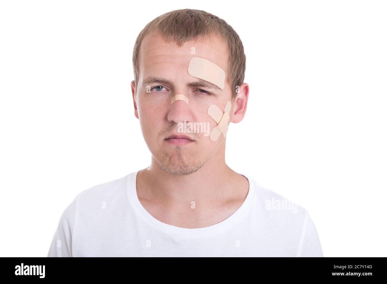 sad and injured young man with adhesive plaster on his face Stock Photo