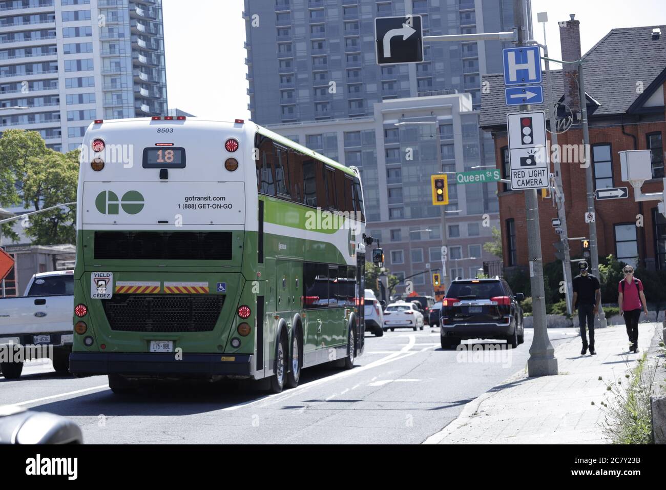 Go Transit public bus seen at a stoplight on Main street heading to downtown city center Stock Photo