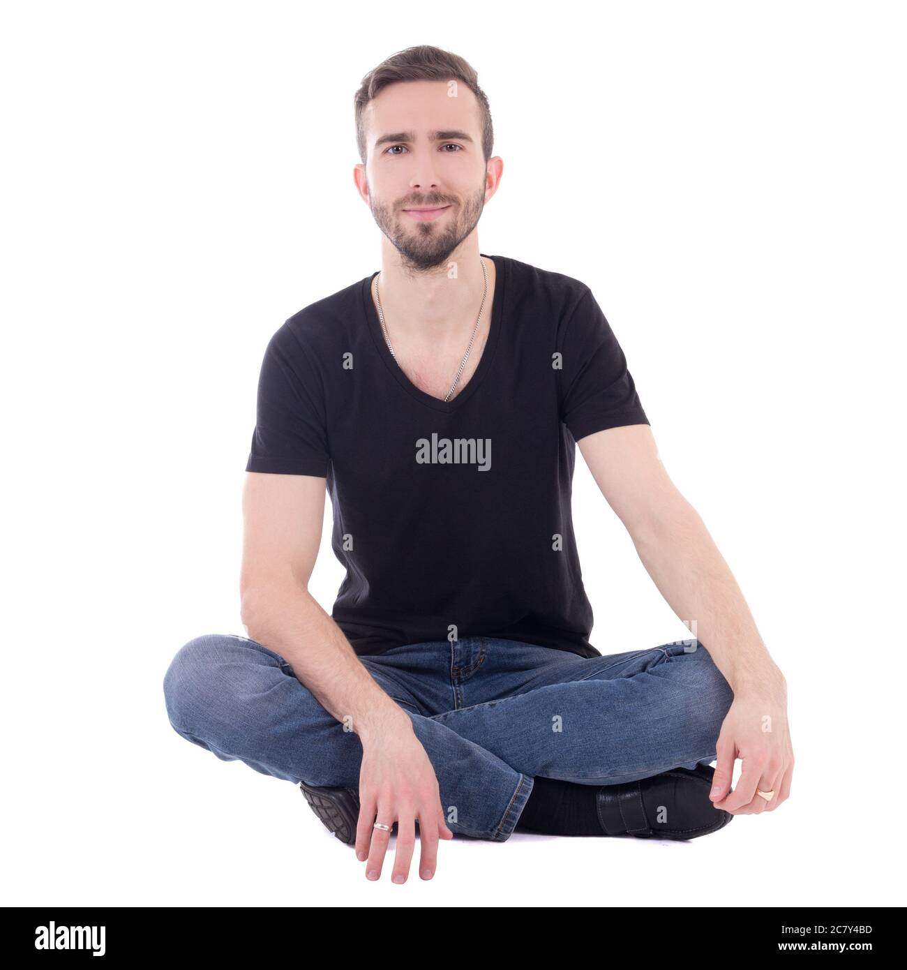 happy young man sitting on the floor isolated on white background Stock ...