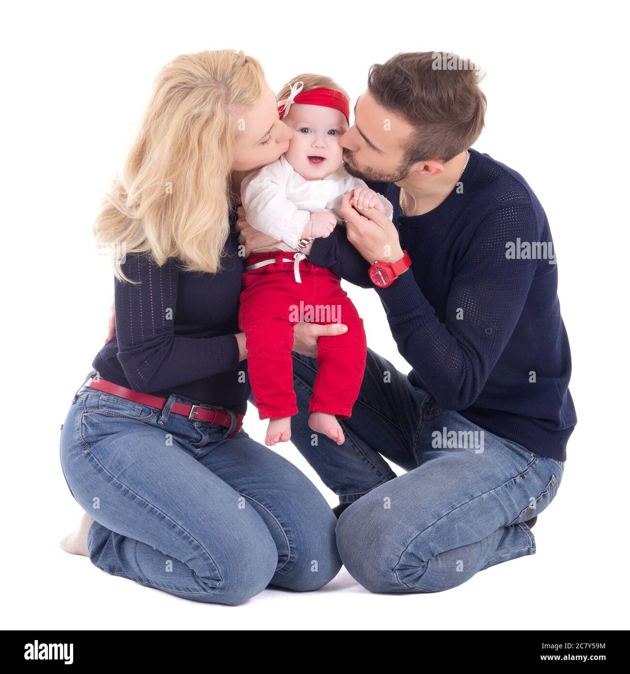happy young family - father and mother kissing little daughter isolated on white background Stock Photo