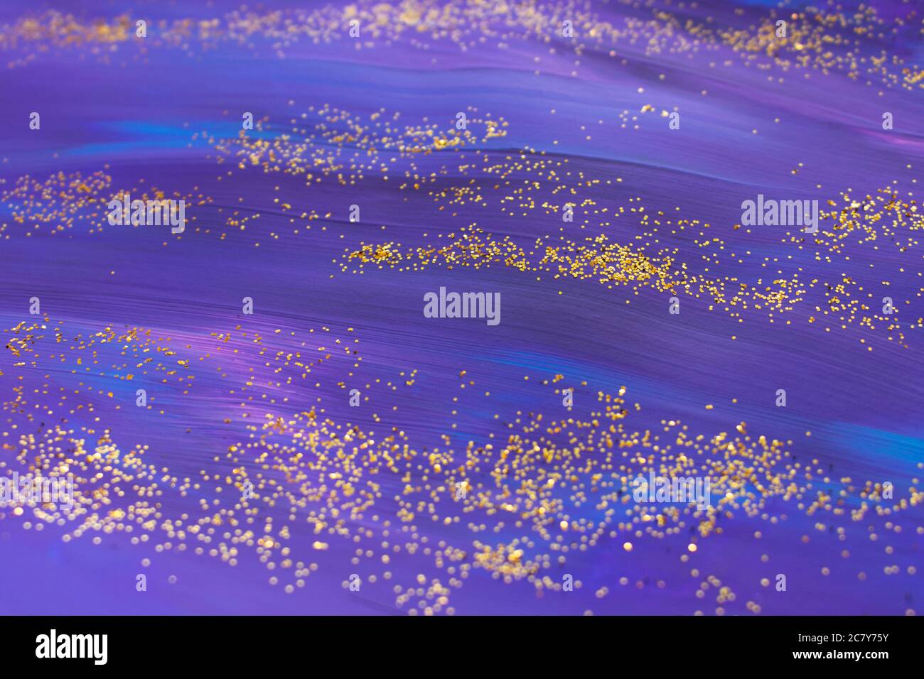 Dark acrylic hand drawn texture in violet colour with golden glitter. Festive backdrop. Stock Photo