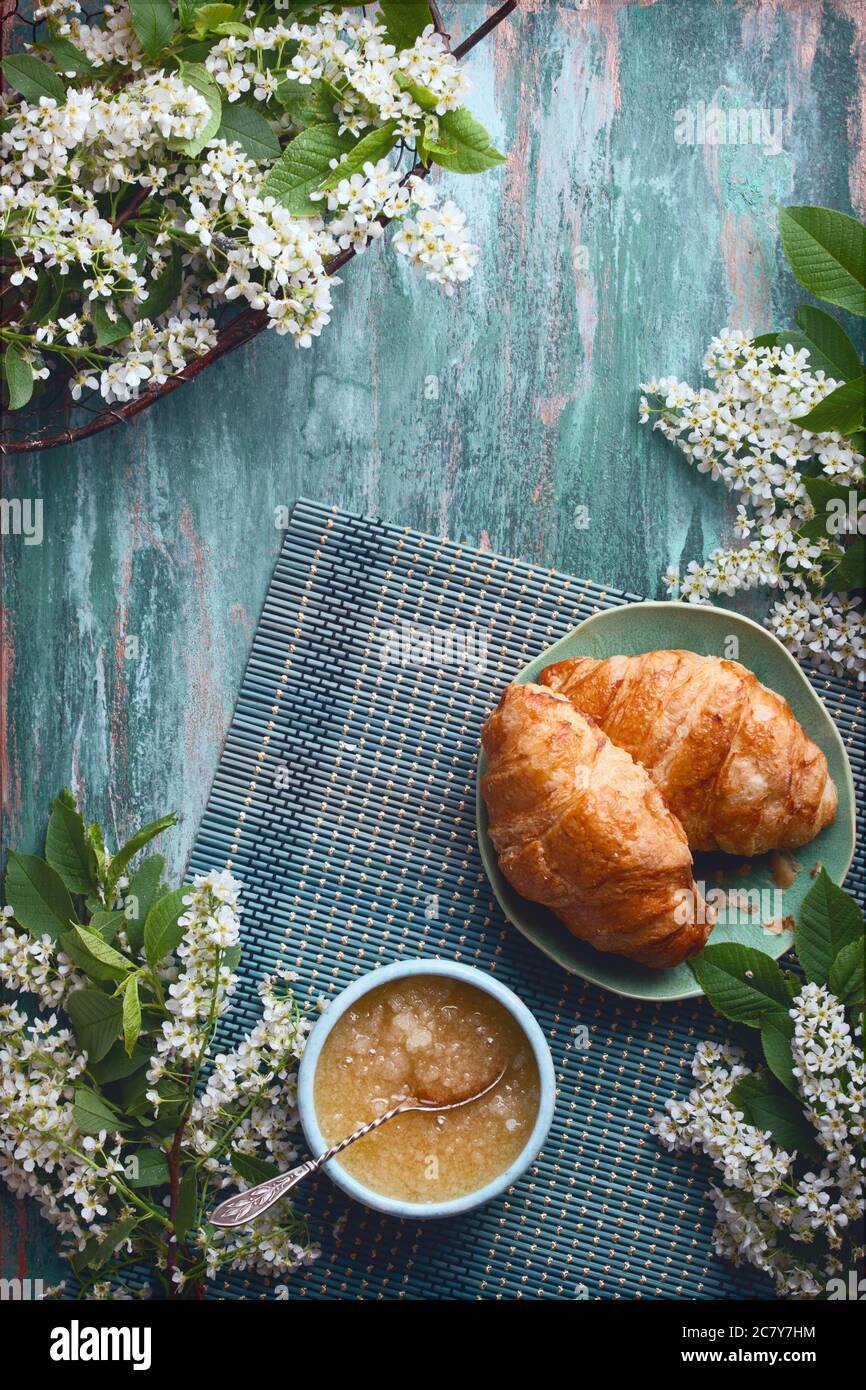 flatlay food background - empty wooden board with croissants and honey, with copy space for text Stock Photo