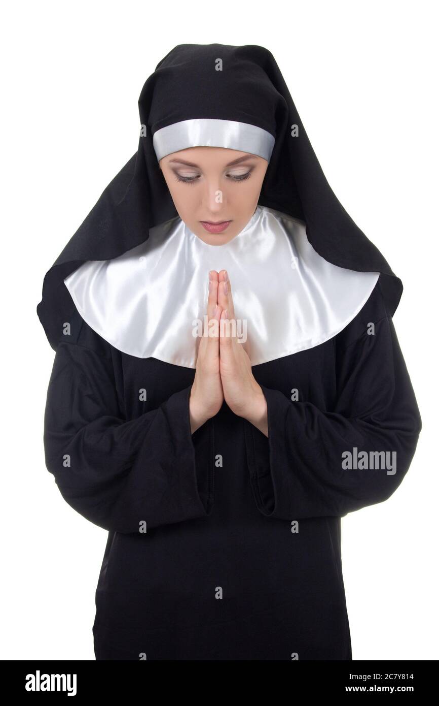young woman nun praying isolated on white background Stock Photo