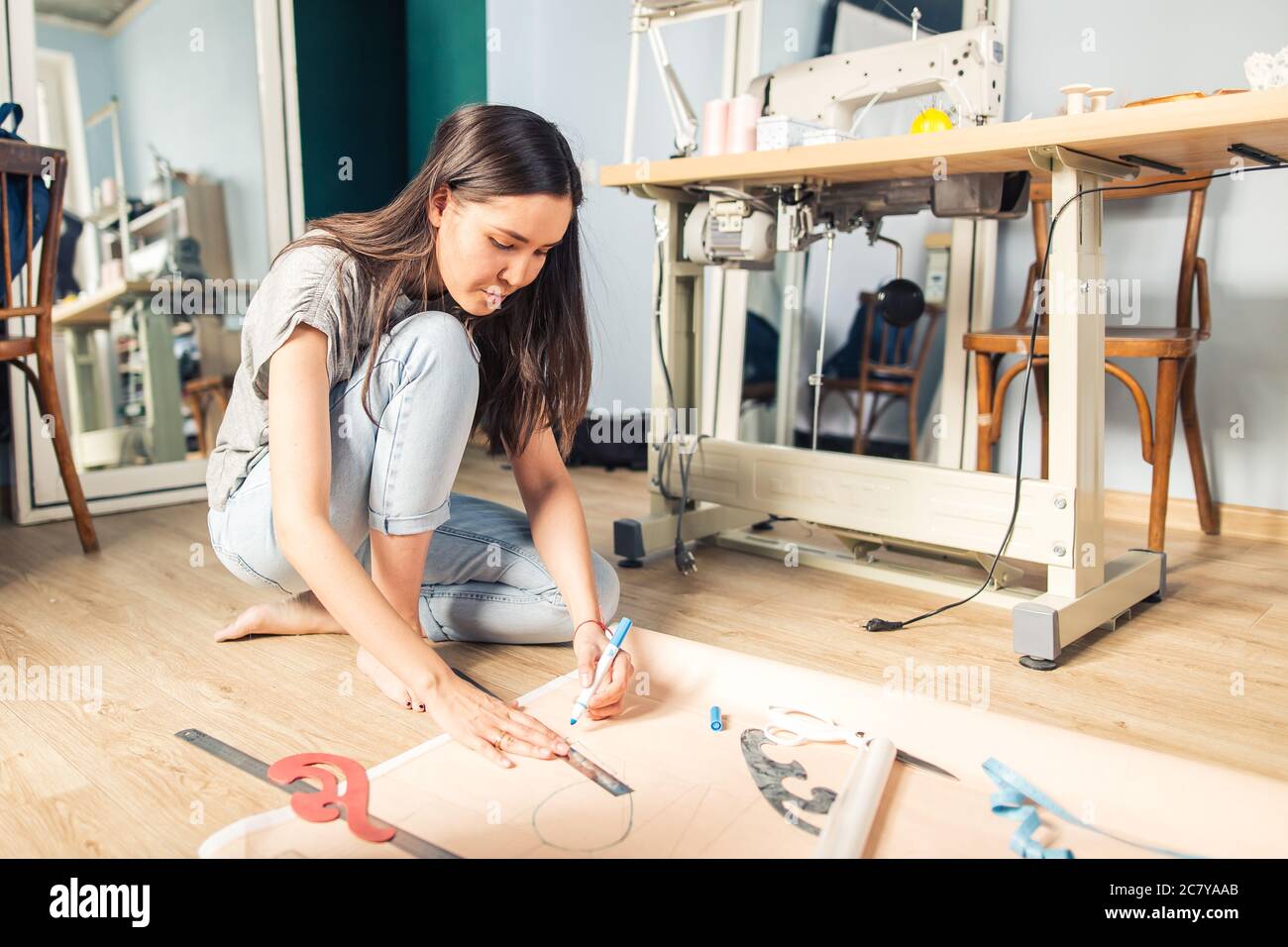Close up. hands woman Tailor working cutting a roll of fabric on which